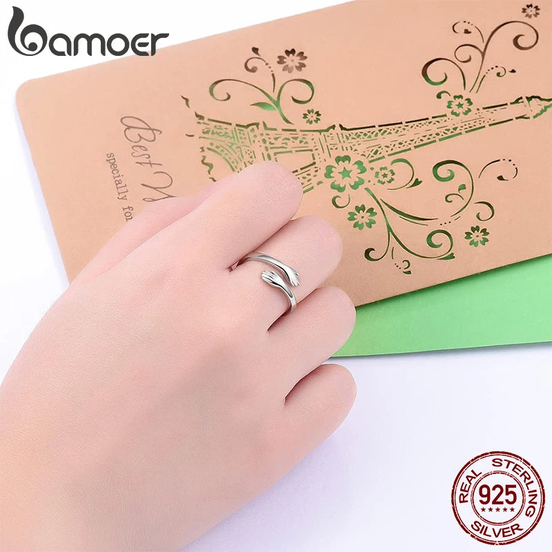 Sterling Silver Warmth Adjustable Ring displayed on a hand with a special greeting card background.