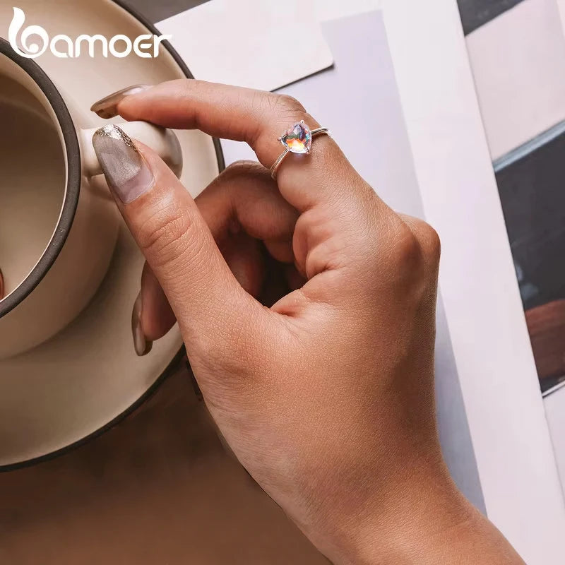 Luxury Sterling Silver Wedding Engagement Ring worn on a hand holding a coffee cup, featuring a radiant zircon centerpiece.
