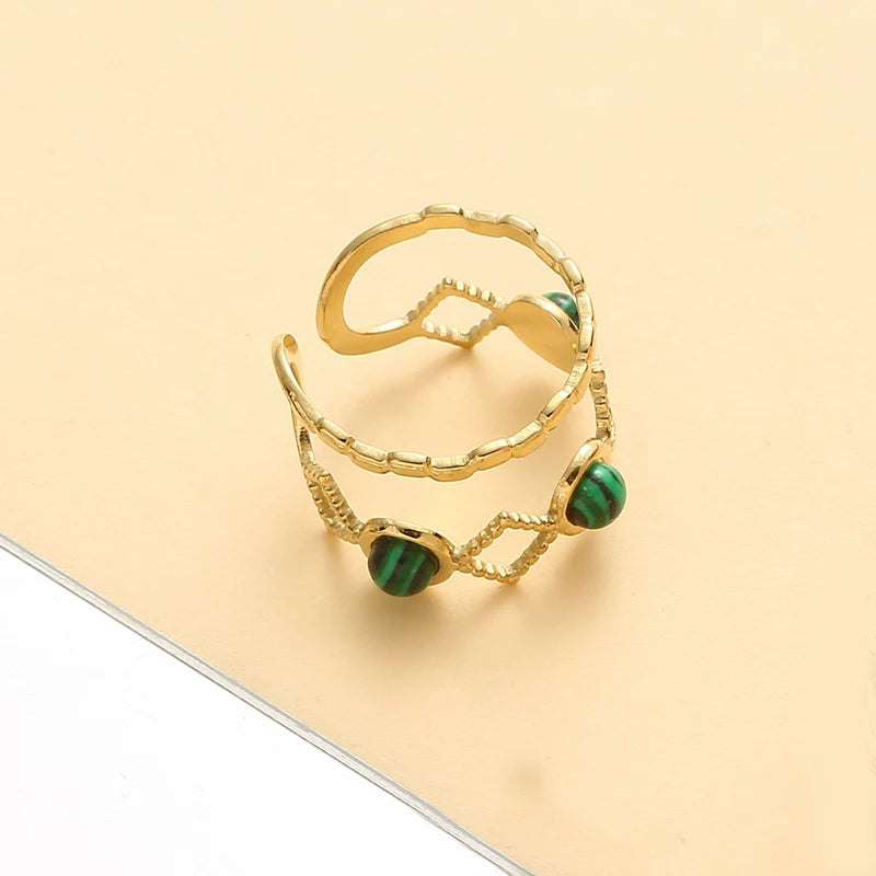 Timeless trendy stone layered ring - featuring gold design with green stones on a light background.