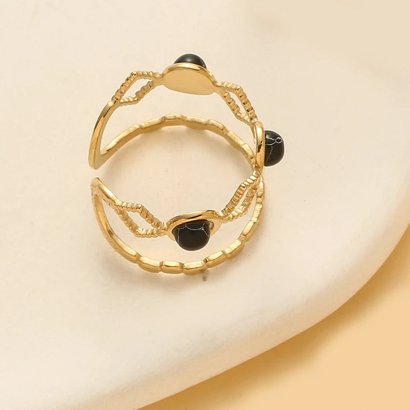 Timeless trendy stone layered ring - featuring a chic design with black stones, crafted in gold.