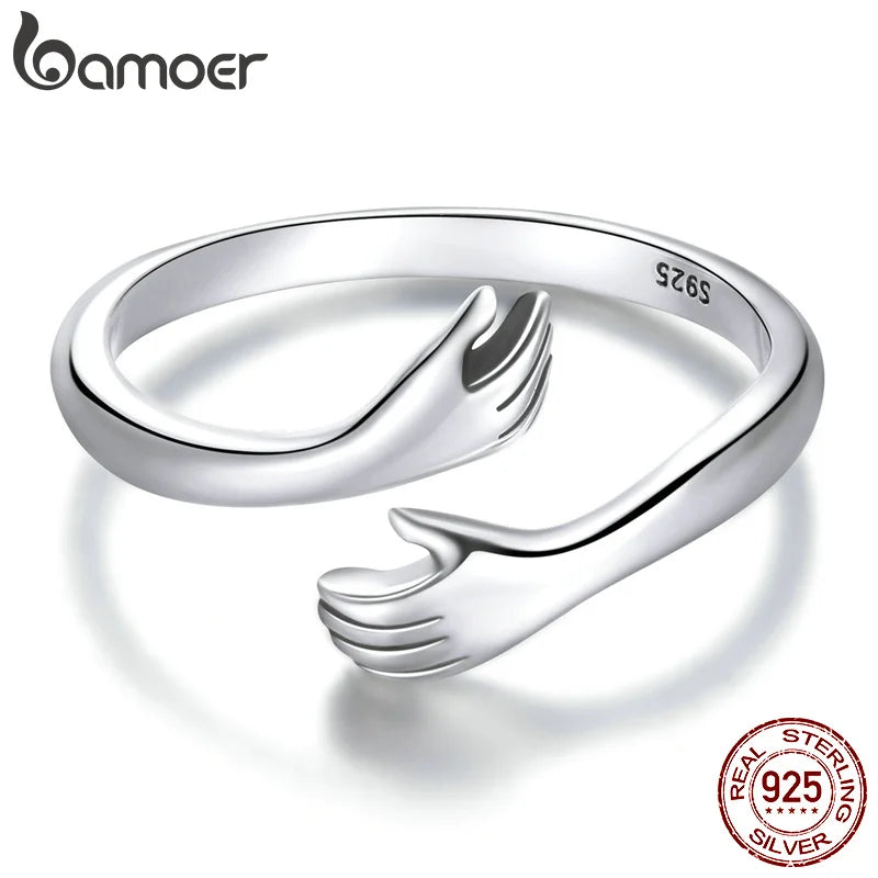 Sterling Silver Warmth Adjustable Ring featuring a hand-hug design, symbolizing care and affection.