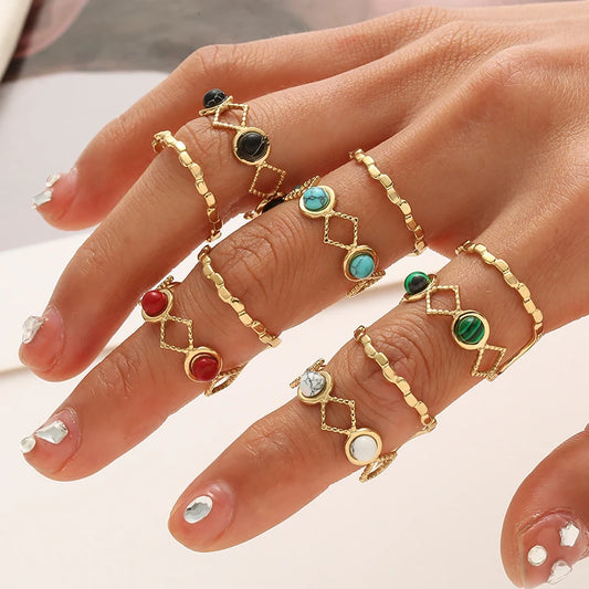 Timeless trendy stone layered ring - showcasing multiple gold rings with colorful stones on a hand.